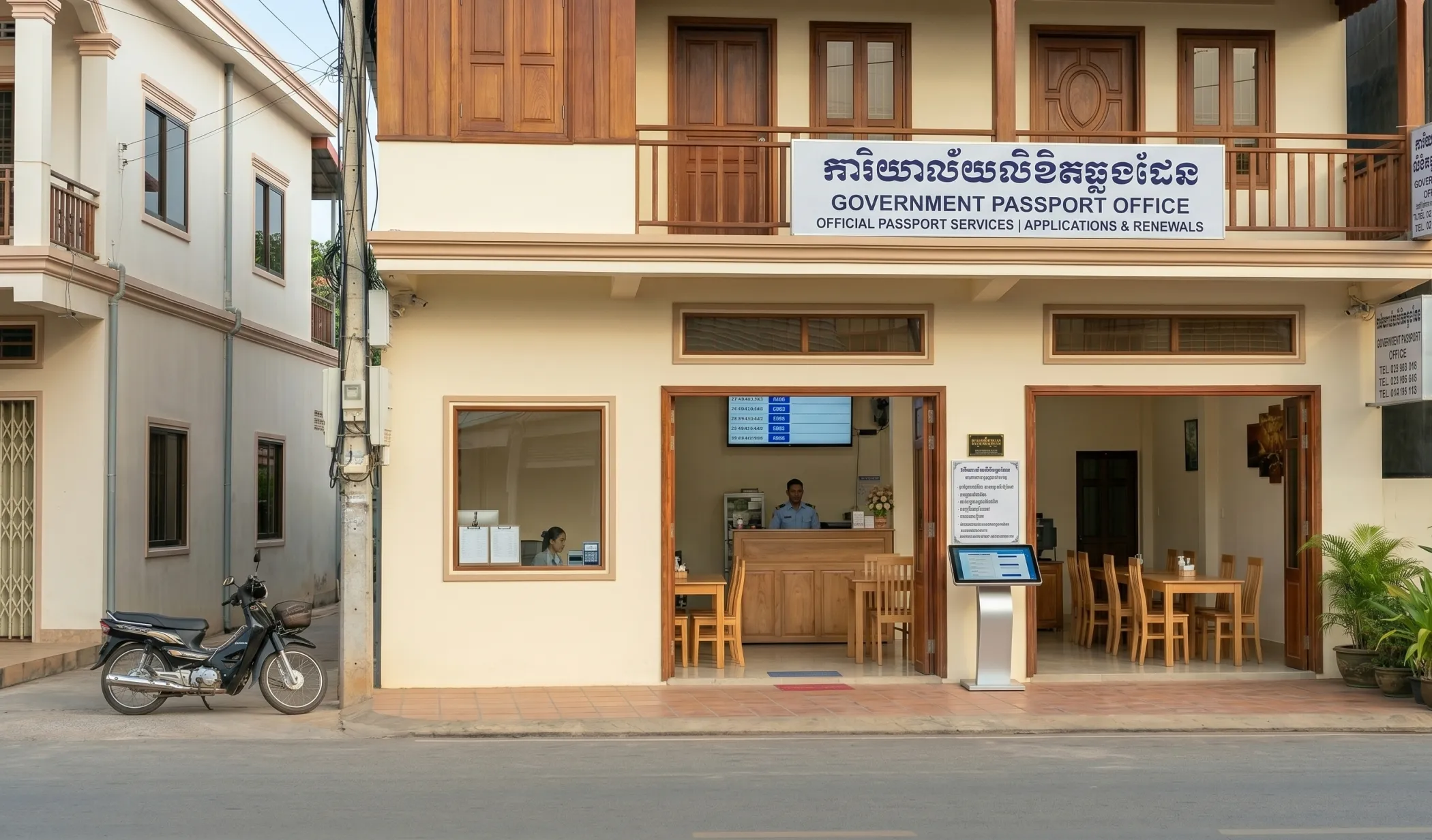 A Cambodian government administrative office seen through a window - wooden counter, ceiling fan, stacked papers