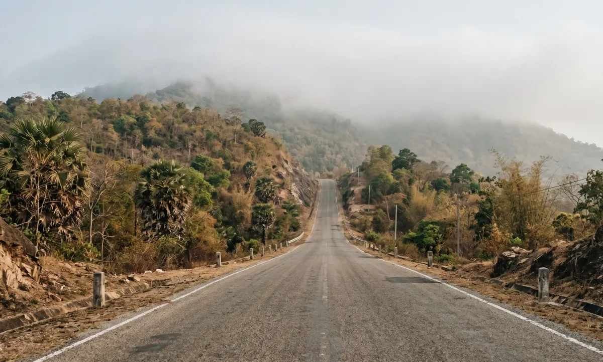 A mountain road in southern Cambodia rising into low cloud